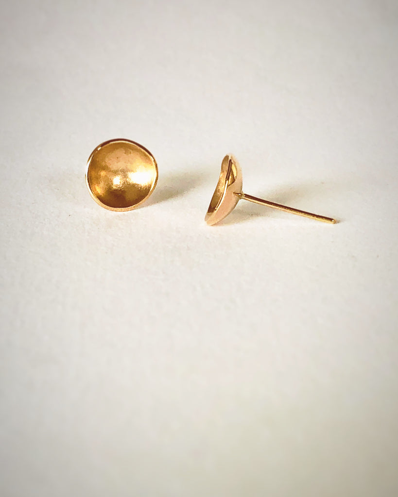 close up of 24k gold domed handmade stud earrings