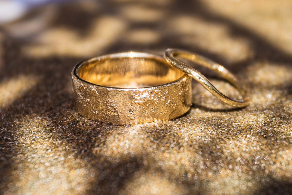 14k solid gold his and hers sand-textured wedding bands.