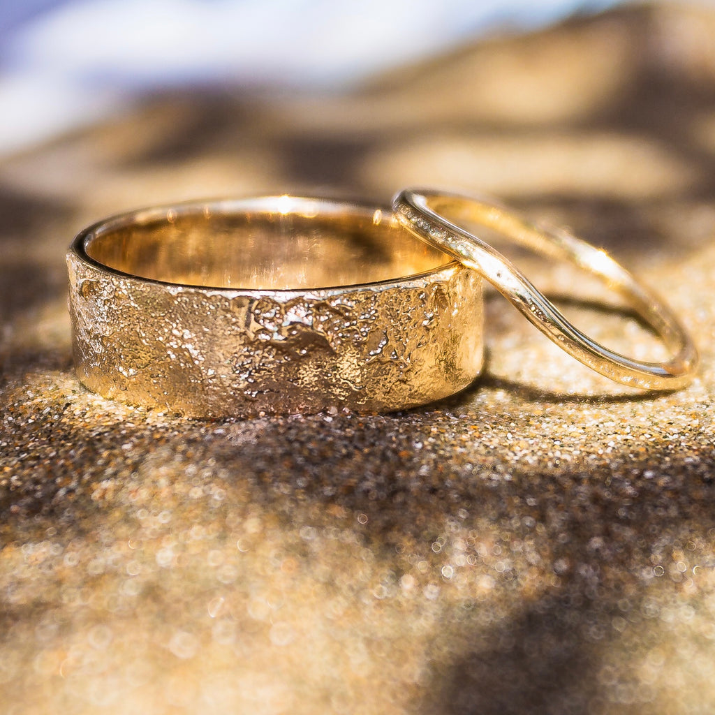 14k solid gold his and hers sand-textured wedding bands.