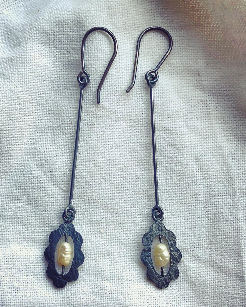 Handmade long Oxidised silver dangle earrings.  Small vintage pearl in scalloped -edged frame suspended on long bar and hook.