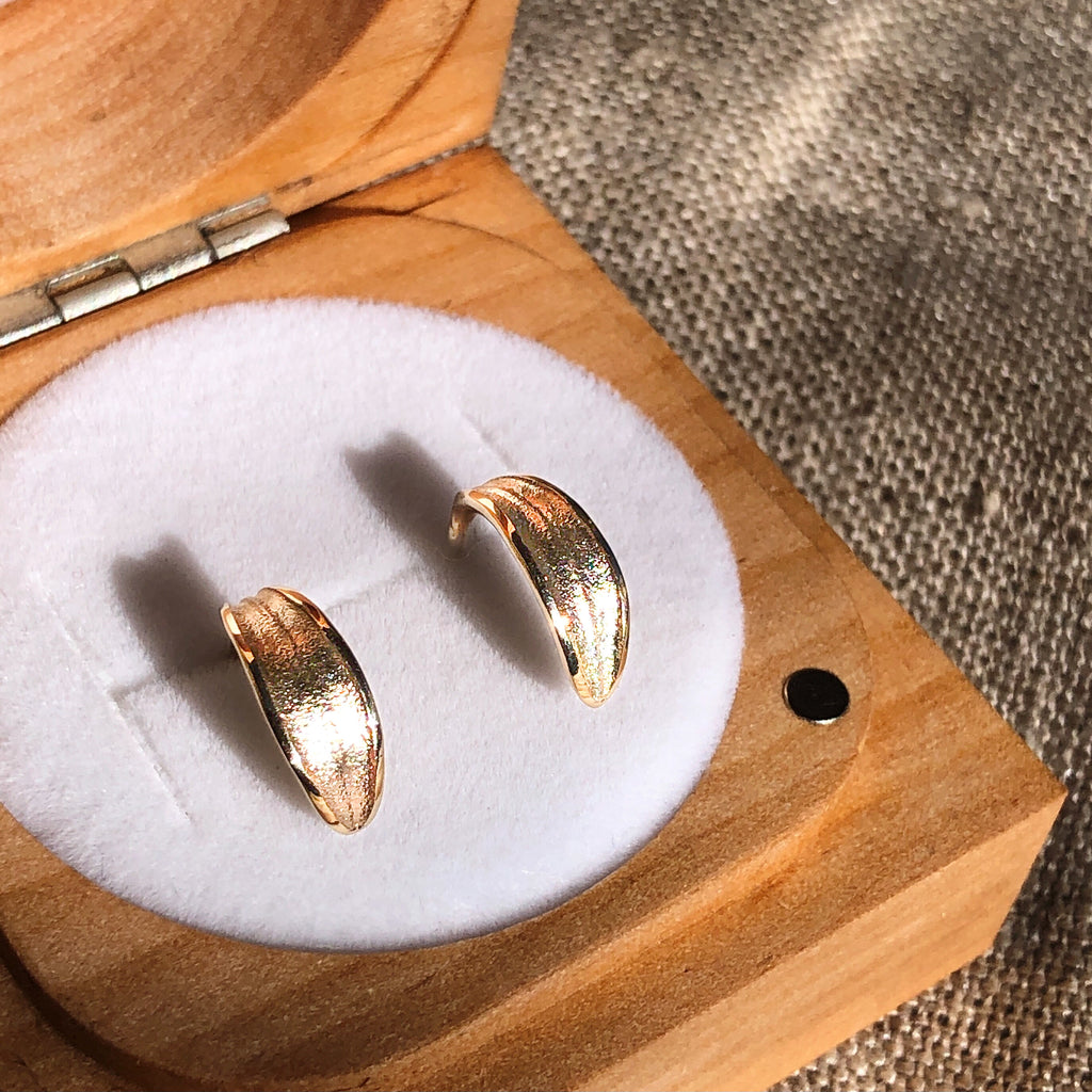 Solid 9k gold olive leaf huggie stud earrings in wooden ring box.