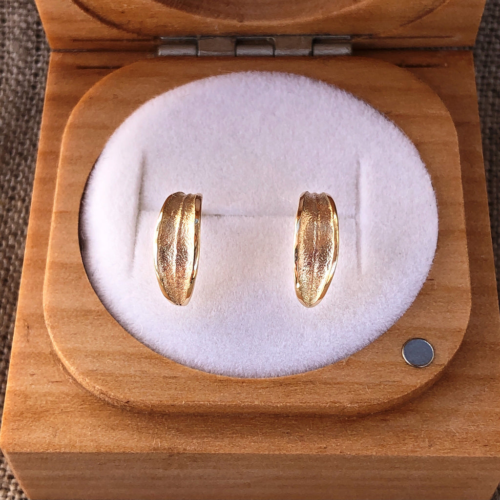 Solid 9k gold olive leaf huggie stud earrings in wooden ring box.