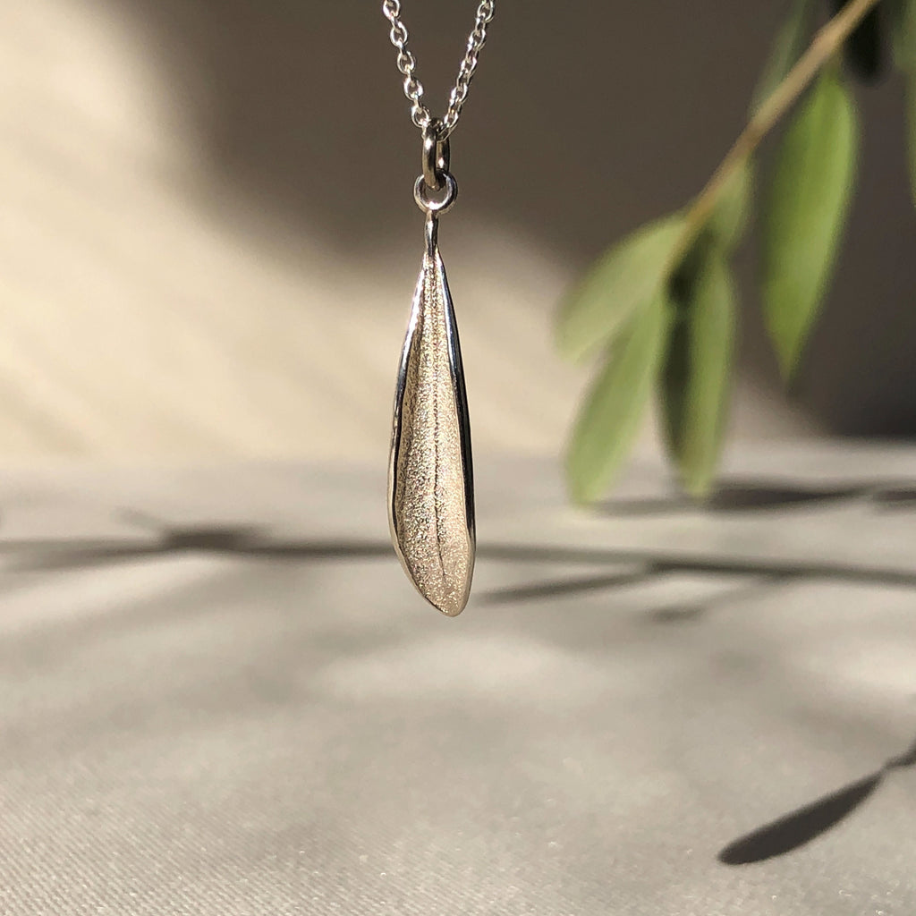 Handmade sterling silver olive leaf pendant.  Hangs on a fine sterling silver cable chain.